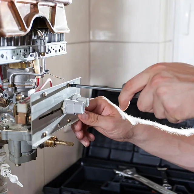 plumber repairing a boiler