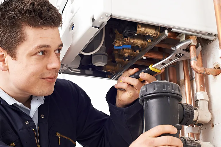 plumber repairing a boiler