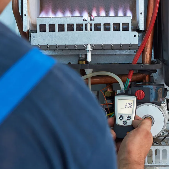 plumber fixing a boiler